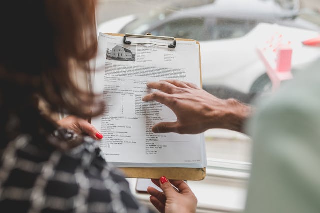 two-people-looking-at-clipboard